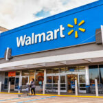 Walmart Body-Slam Captured—Witnesses Thought He DIED… Walmart storefront with people and shopping carts outside.