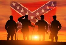 Tax Weapon DEPLOYED Against Confederate Heritage Organizations… Silhouetted soldiers saluting against a sunset backdrop with a Confederate flag