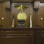 Court SHOCKER: Murdaugh Convictions Overturned—Jury TRAINED! Judges bench in an empty courtroom, scales emblem above.
