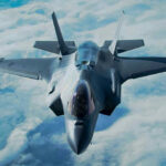Cuba Tension IGNITES: Indictment TARGETS Castro Stealth fighter jet flying above the clouds.