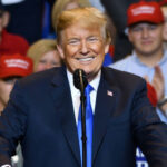 Trump’s SHOCKING Attack on Lauren Boebert… smiling man in a navy suit speaking at a rally