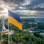 Russia Warns: Kyiv’s Next SHOCK Strike Coming! Ukrainian flag waving in front of a monument with a city skyline in the background