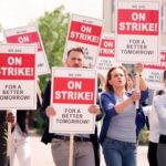 Election TRUST CRISIS—Petition Worker Exposed Group of people holding signs protesting for better working conditions