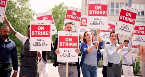 Workers,Strike,Demonstration,In,City.,Labor,Union,March.,Protest,Rally Group of people holding signs protesting for better working conditions