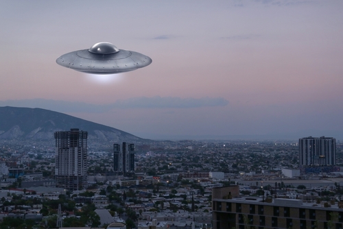 Alien,Spaceship,Flying,Over,City,In,Morning.,Ufo,,Extraterrestrial,Visitors A UFO hovering over a city skyline during twilight