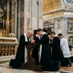 Pope’s AI Bombshell — Unprecedented VATICAN Move! Clergy members kneeling in prayer inside a grand cathedral