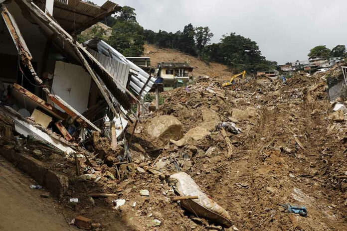 2138336547 Landslide damages houses, debris covers hillside.