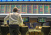 Jeffries’ Skyrocketing Claim Backfires Person viewing stock market data on multiple screens.