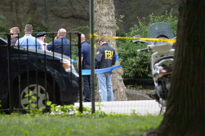 451587268 FBI agents and police officers at a crime scene.