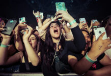 50 Cent Torches Smollett Comeback Concert crowd cheering and taking photos with phones.