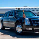 Taxpayer-Funded ‘Palace’ Becomes Air Force One A black presidential limousine parked at an airport with Air Force One in the background.