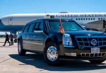 Taxpayer-Funded ‘Palace’ Becomes Air Force One A black presidential limousine parked at an airport with Air Force One in the background.