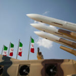 Iran Provokes, CENTCOM Strikes Back Missiles on launchers beside Iranian flags.