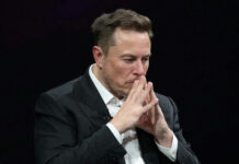 Musk Backing Sparks Right Meltdown Man in suit deep in thought.