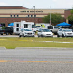 Bullied Teens Unleash Horror High school parking lot with emergency vehicles and tents