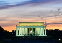 Olympian Cuffed at Lincoln Memorial Lincoln Memorial illuminated at sunset with reflection in water