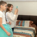 Britain’s Phone Crackdown Goes Nuclear Two children in a bedroom taking a photo with a smartphone