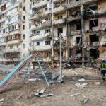 Mystery Strike Torches Key Russian Plant Damaged apartment building with debris scattered firefighters present.
