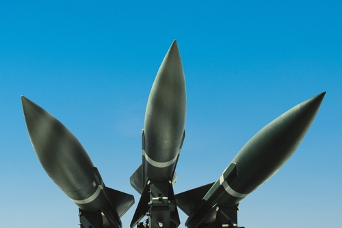 Three,Missiles,Weapons,Rockets,On,A,Blue,Sky,,Concept.,War Three missiles pointed upwards against a clear blue sky