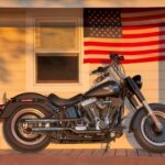 Media Invents Biker ‘War’ For Clicks A black Harley Davidson motorcycle parked in front of a house with an American flag
