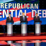 Republican presidential candidates debating on stage, CNN background.