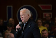 Carville Torches Biden: ‘Tragic’ Meltdown Man speaking into microphone at crowded event.