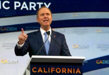 Blue MAGA Bombshell: Dems Chase Trump’s Base Man in suit speaking at a podium with microphones
