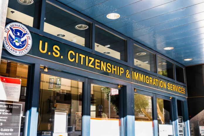 shutterstock_1569360250-1 US Citizenship and Immigration Services building entrance