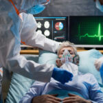 Toxic Mist Hits Manhattan? Patient on hospital bed with oxygen mask assisted by healthcare workers