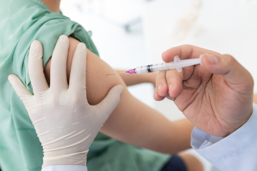 Close,Up,Of,A,Doctor,Making,A,Vaccination,In,The A healthcare professional administering a vaccine to a patients arm