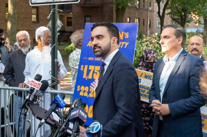 Democratic,New,York,City,Mayoral,Candidate,Zohran,Mamdani,Launches,A Man in suit speaks at outdoor press conference with microphones