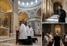 Clergy members kneeling in prayer inside a grand cathedral
