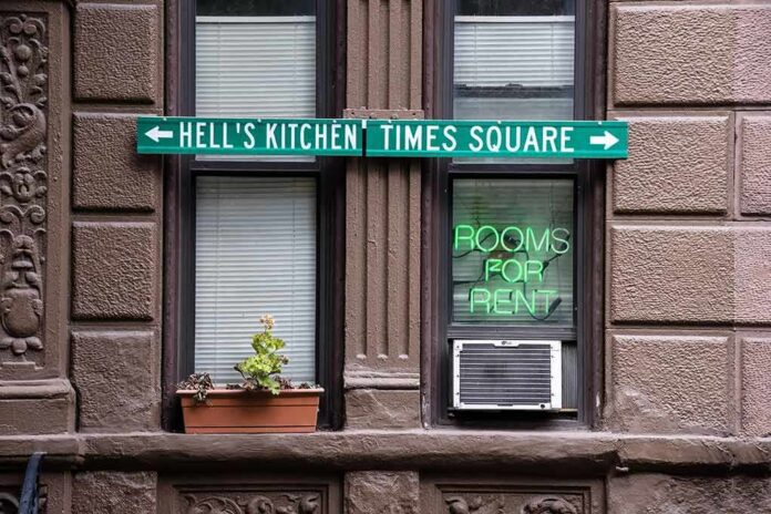 shutterstock_404250745 Apartment facade with windows, neon sign, and street direction sign