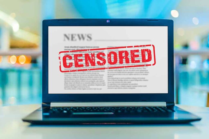 Laptop screen displaying censored news article.