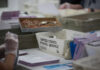 Workers handling mail-in ballots at a postal service.