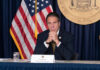 Governor Andrew Cuomo sitting at a conference table.