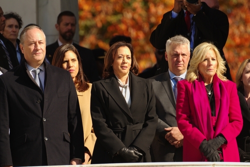 Group of people standing outside in formal attire.